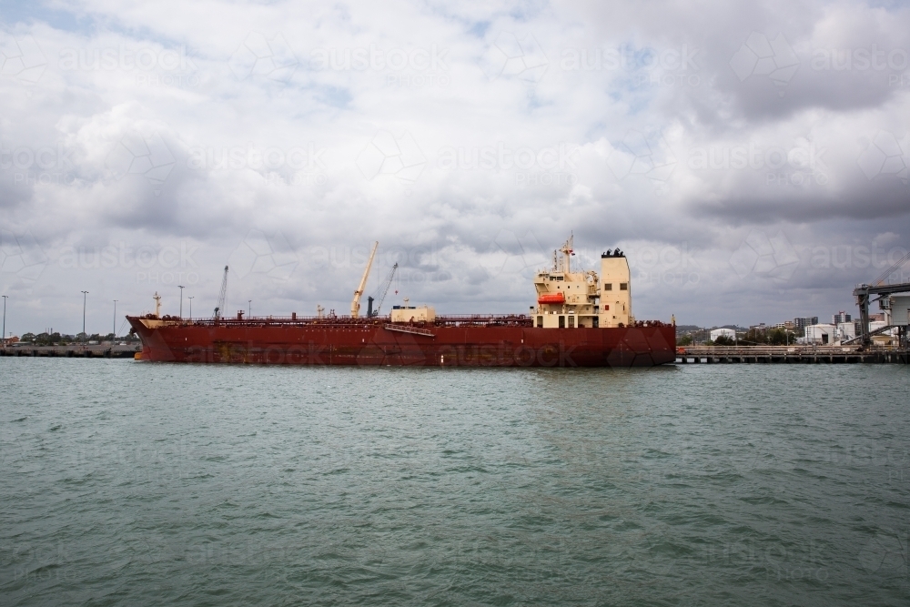 Image of Gladstone harbour large dark red ship at the dock - Austockphoto