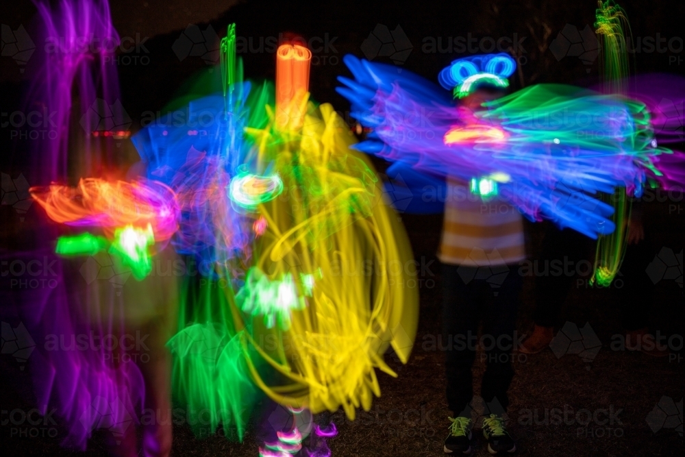 Glow stick patterns long exposure at night - Australian Stock Image