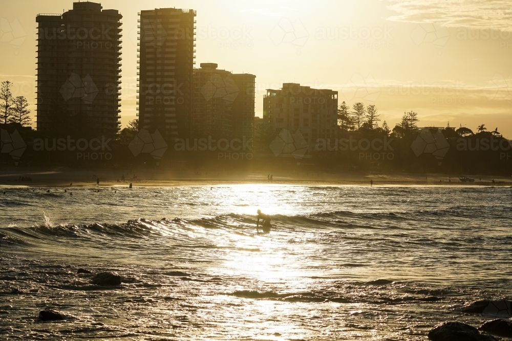 Golden light over beach and buildings - Australian Stock Image