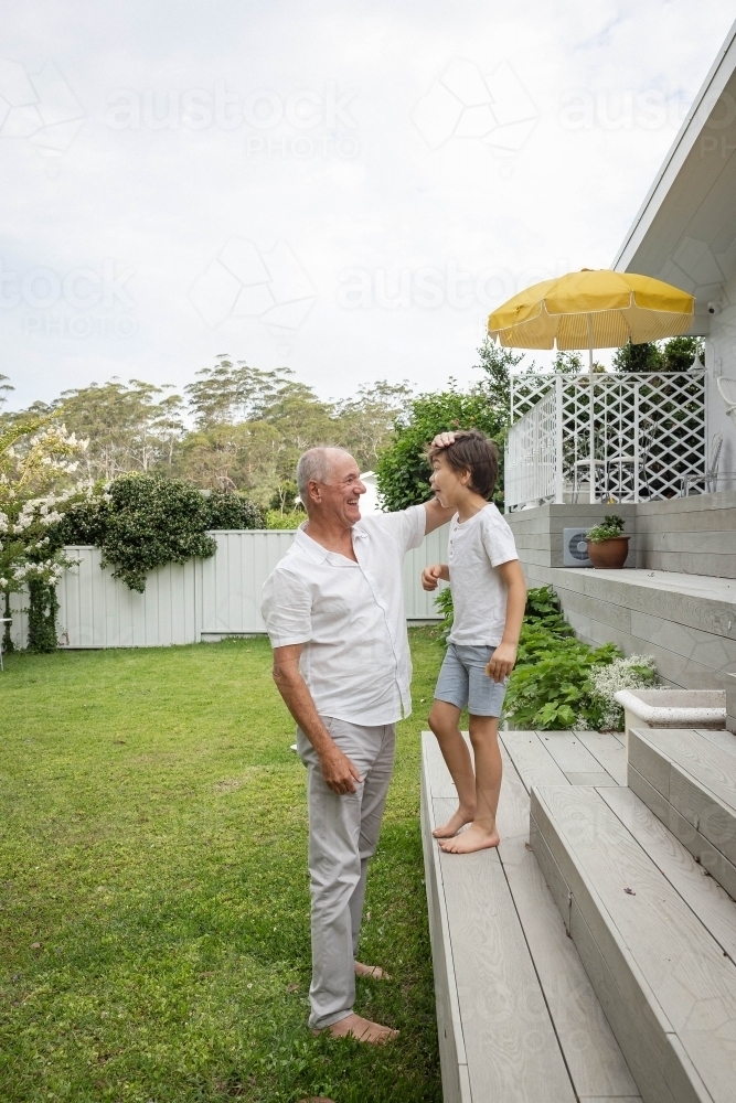 Grandad and grandson in backyard - Australian Stock Image
