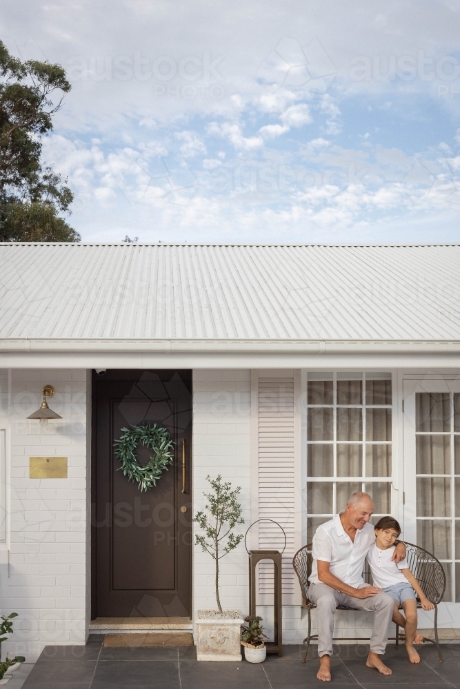 Grandad and grandson on porch together - Australian Stock Image