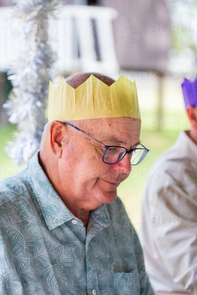 Grandfather in Christmas cracker hat - Australian Stock Image