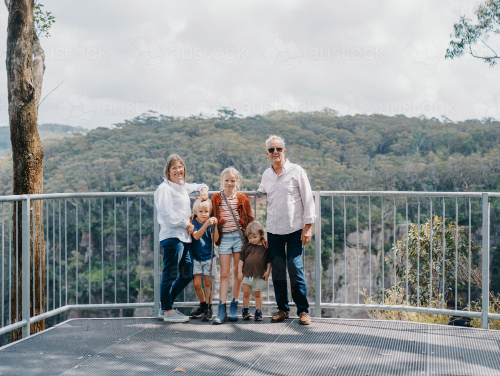 Grandparents enjoying Australian Bushland with their Grandchildren standing at lookout - Australian Stock Image