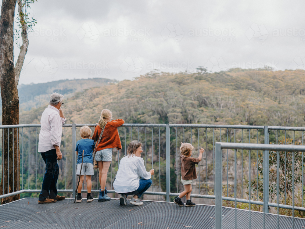 Grandparents enjoying Australian Bushland with their Grandchildren standing at lookout with view - Australian Stock Image