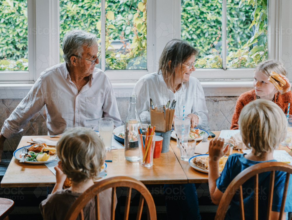 Grandparents enjoying lunch with their young grandchildren - Australian Stock Image