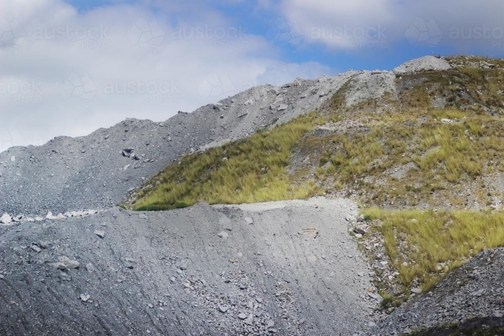 Grass growing on piles of slag from a coal mine - Australian Stock Image