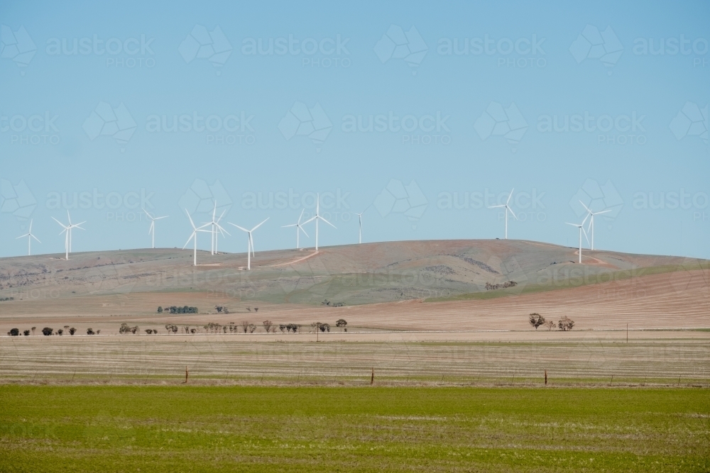 Grassland with wind turbines on hilltop - Australian Stock Image