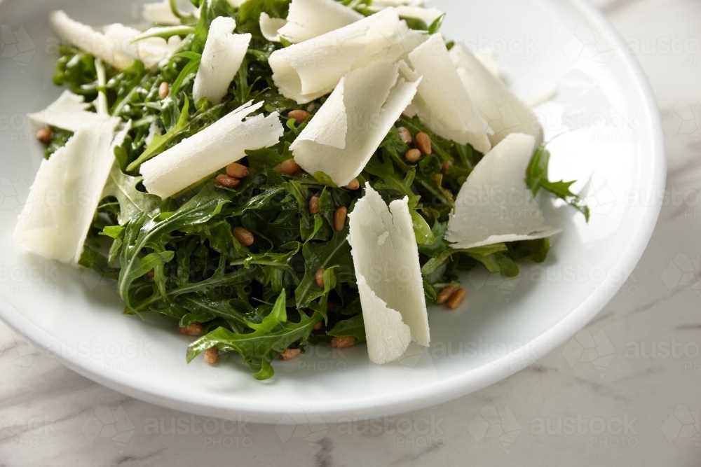 green salad mixed with nuts and shaved cheese - Australian Stock Image