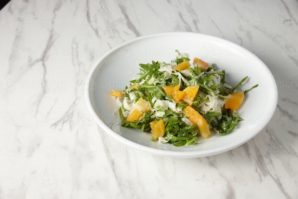 green salad with orange slices and grated cheese - Australian Stock Image