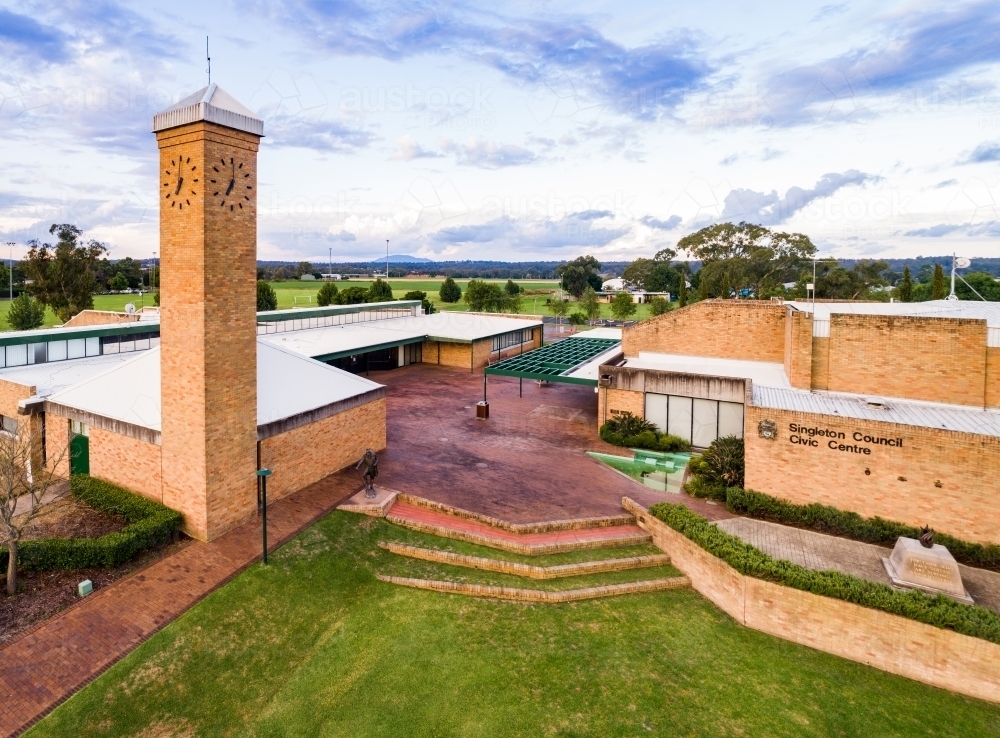 Green with stairs up to council buildings and community hall with clock tower - Australian Stock Image