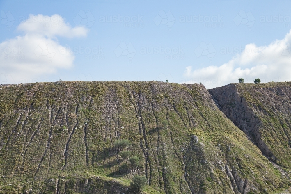 Greenery growing on slag heap of open cut coal mine - Australian Stock Image