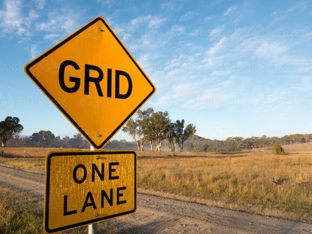 GRID and ONE LANE sign on a dirt road - Australian Stock Image