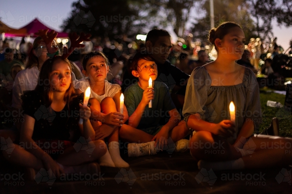 group of kids at Christmas carols in the evening - Australian Stock Image