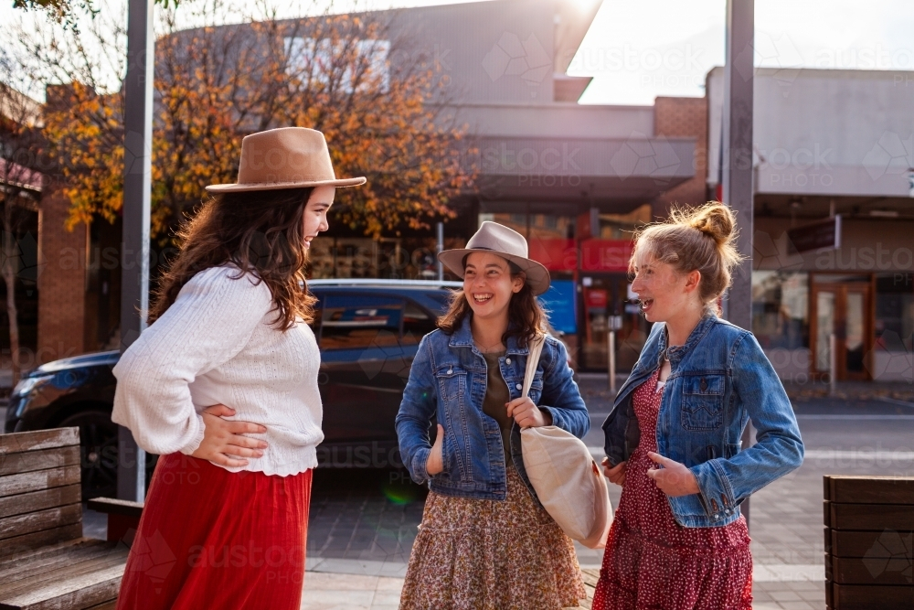 Group of teen girls chatting together in urban setting in country town - Australian Stock Image