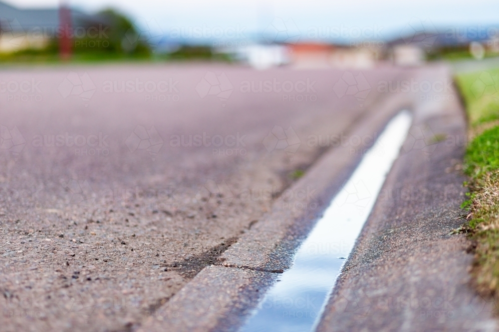 Gutter on roadside with water sitting in it - drainage issues - Australian Stock Image