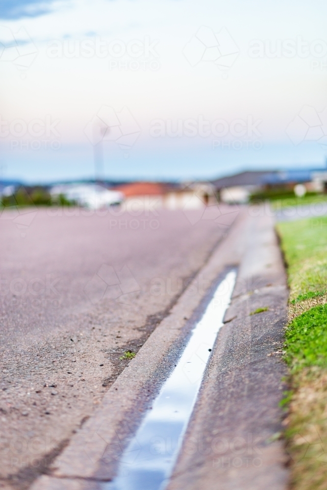 Gutter on roadside with water sitting in it - drainage issues - Australian Stock Image