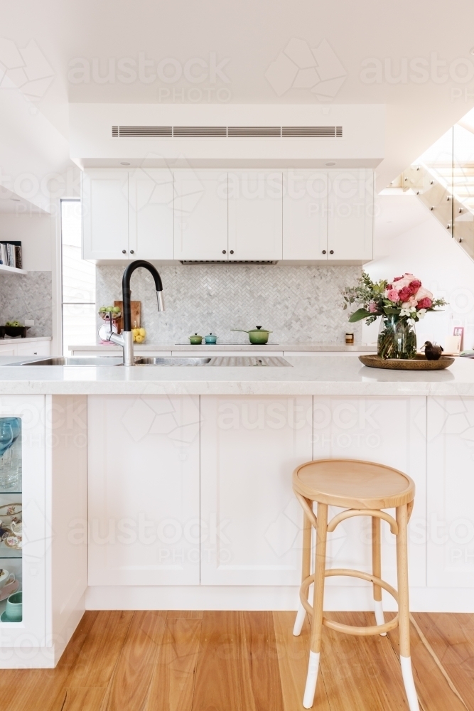 Hamptons styled kitchen with marble herringbone splash back - Australian Stock Image