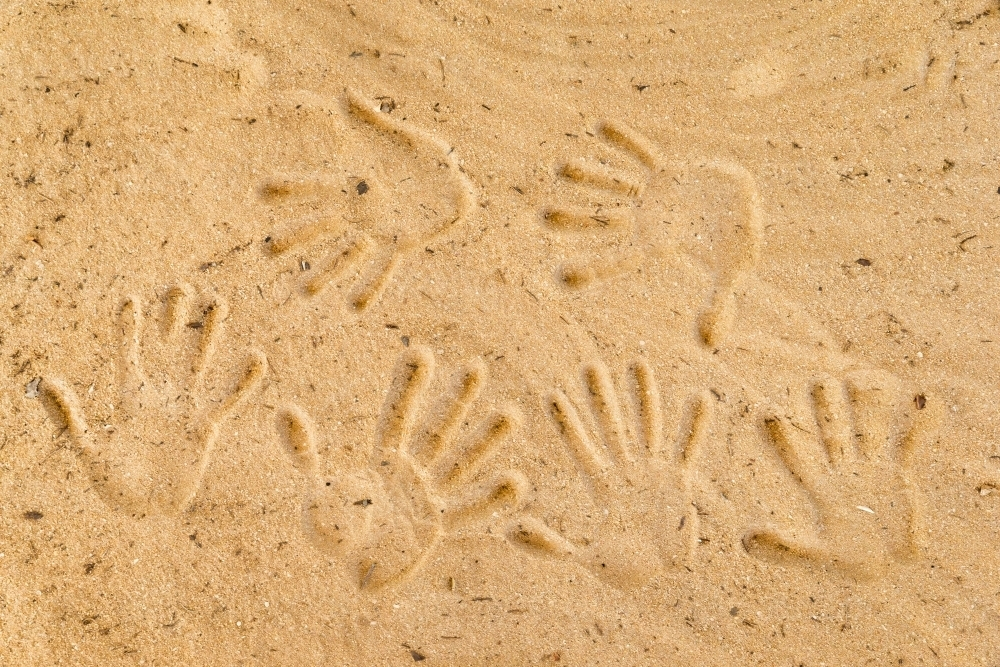 Handprints pressed into the sandy surface. - Australian Stock Image