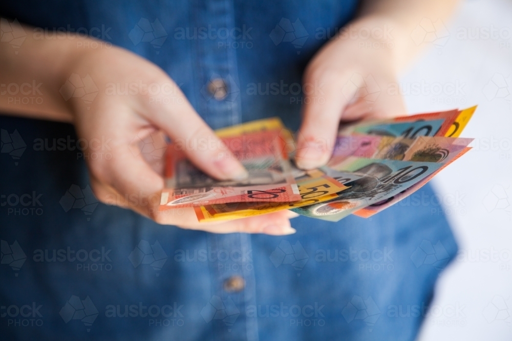 Hands counting Australian money notes - Australian Stock Image