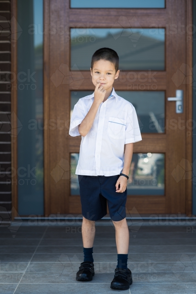 Handsome boys in school uniform leave home for their first day of school - Australian Stock Image