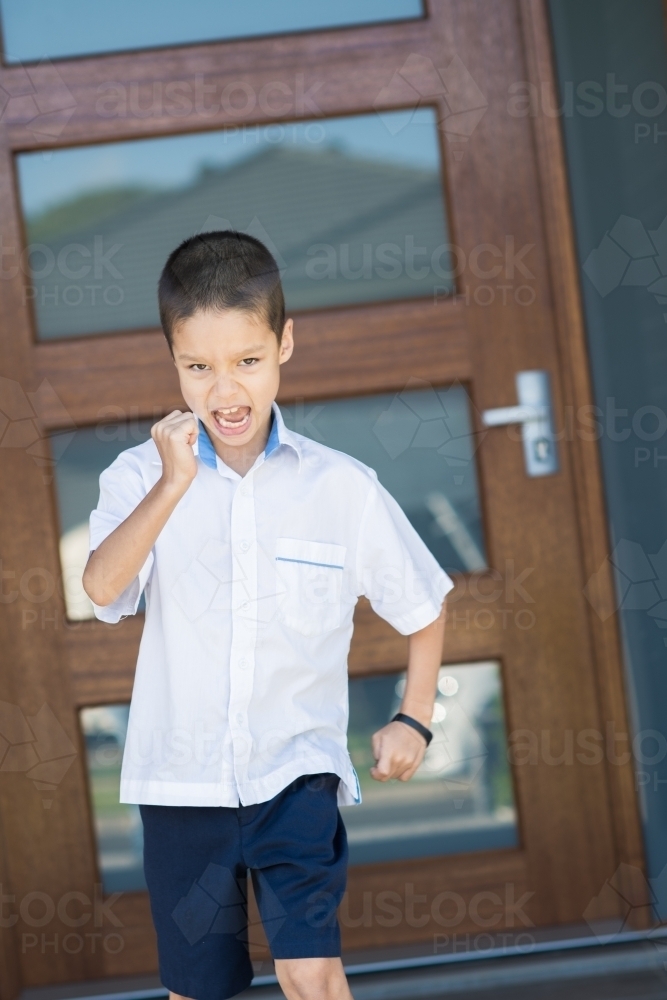 Handsome boys in school uniform leave home for their first day of school - Australian Stock Image