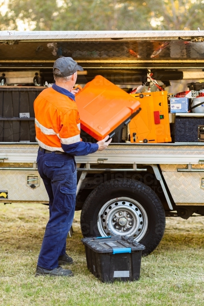 Handyman getting tools from back of tradie ute - Australian Stock Image