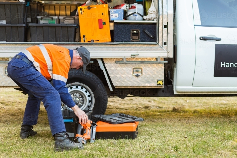 handyman getting tools out of vehicle - Australian Stock Image