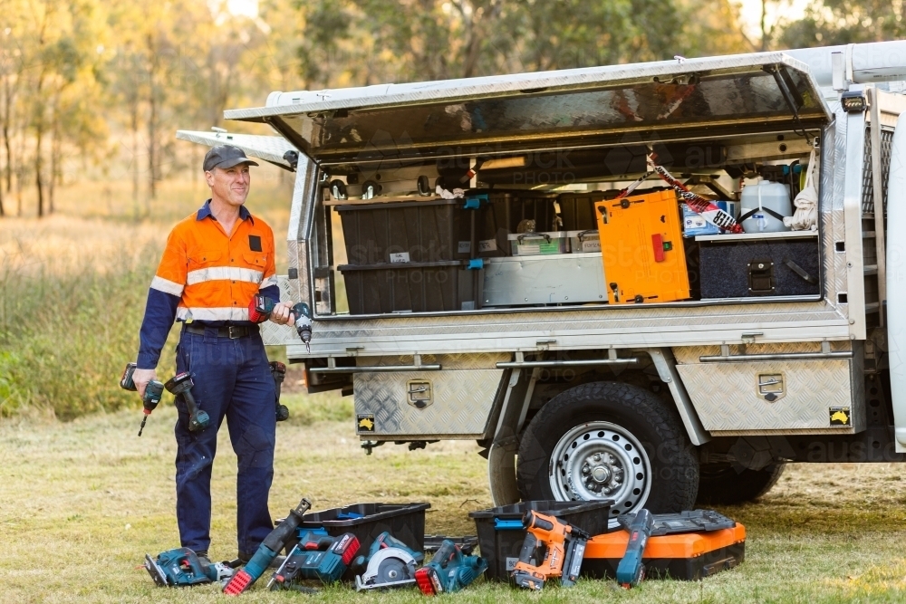 Handyman tradie with power tools and ute ready for work - Australian Stock Image