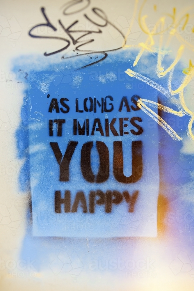 Happiness slogan graffiti on wall - Australian Stock Image