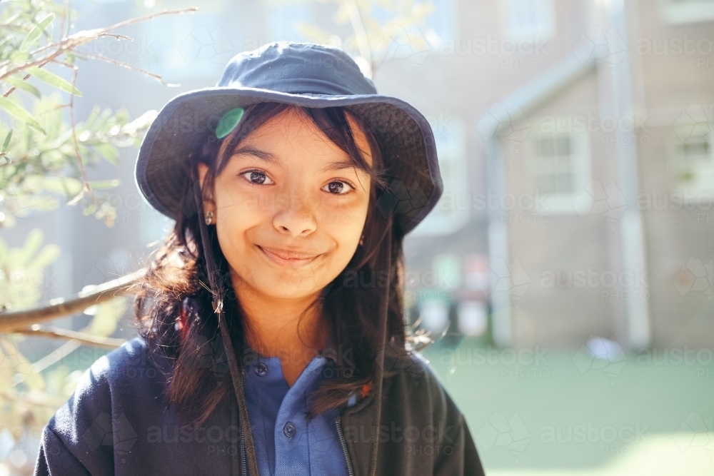 Happy Australian school student in the playground at school - Australian Stock Image