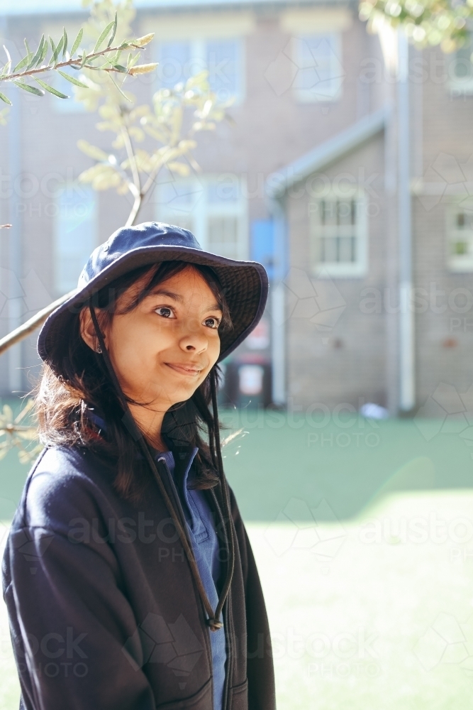 Happy Australian school student in the playground at school - Australian Stock Image