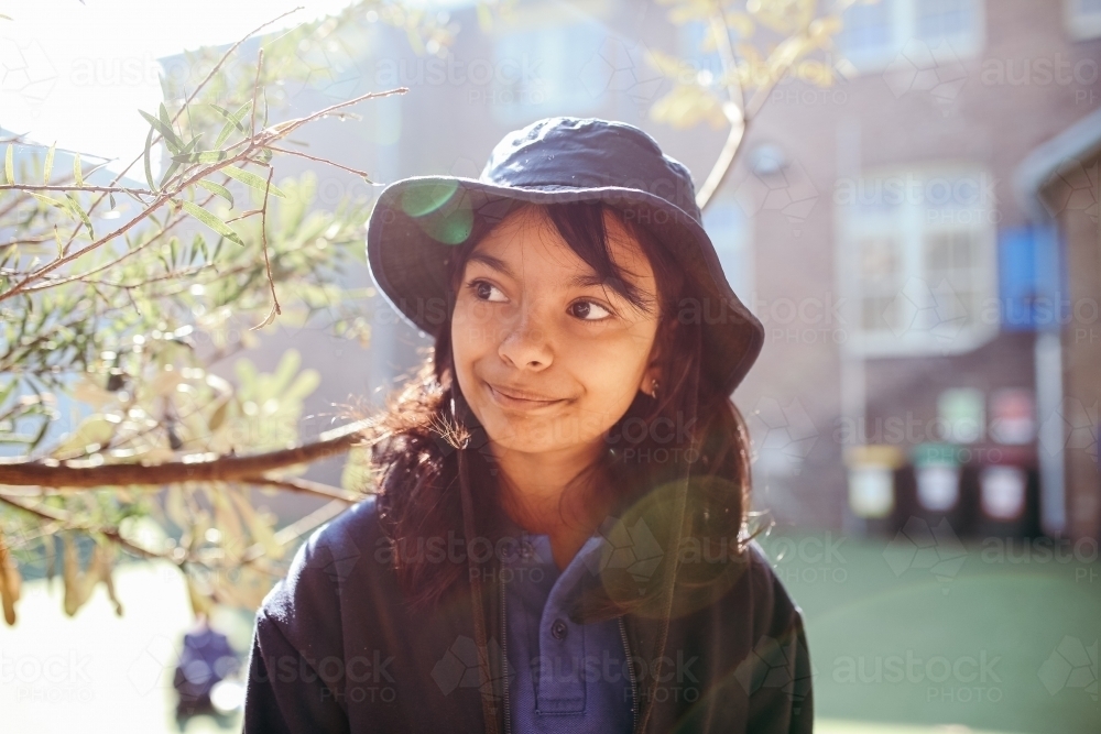 Happy Australian school student in the playground at school - Australian Stock Image