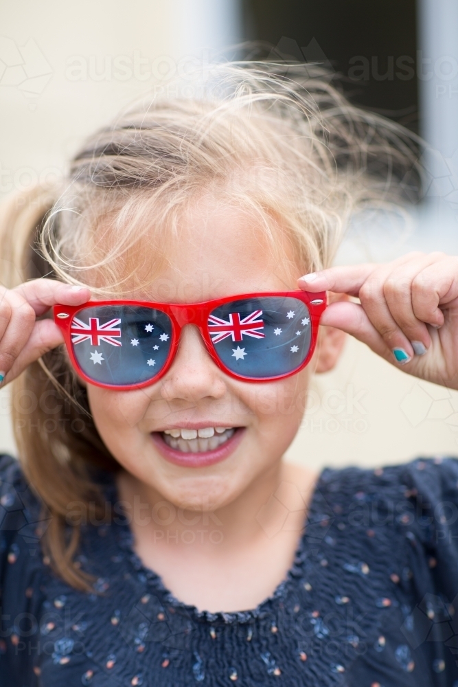 Happy child wearing Australian Flag sunglasses - Australian Stock Image