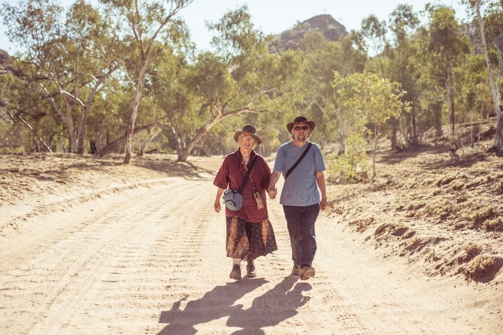 Happy elderly couple holding hands - Australian Stock Image