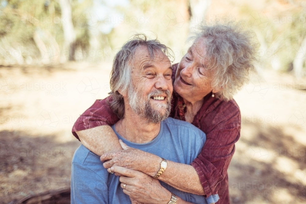 Happy elderly couple hug in the Northern Territory - Australian Stock Image