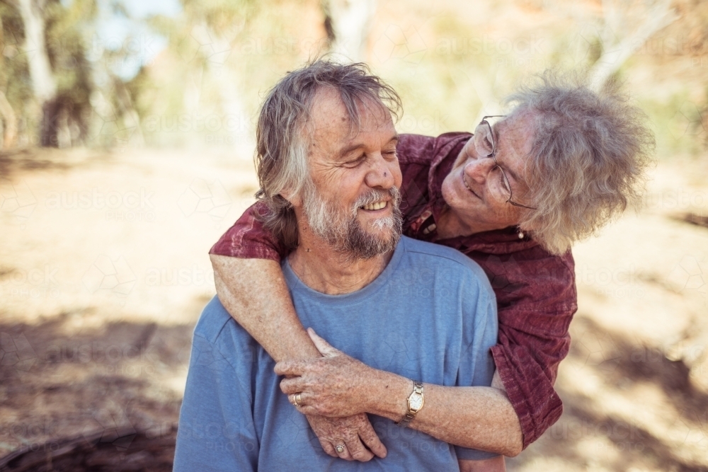 Happy elderly couple hug in the Northern Territory - Australian Stock Image