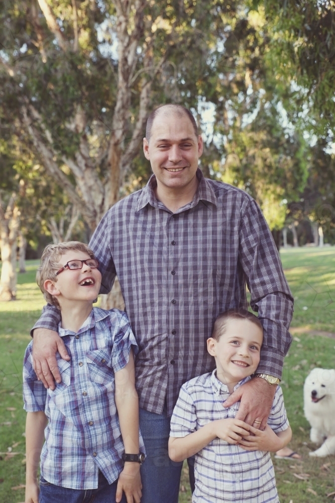 Happy father and sons in the park - Australian Stock Image