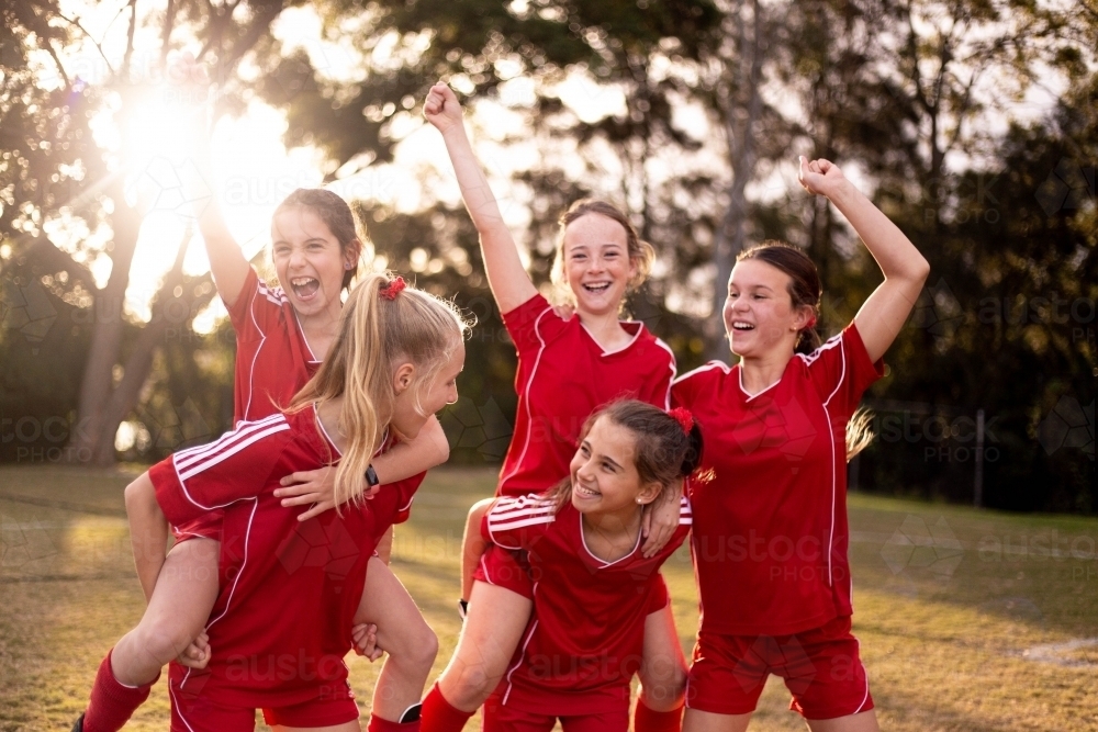 Image of Happy football team of tween girls celebrating together ...