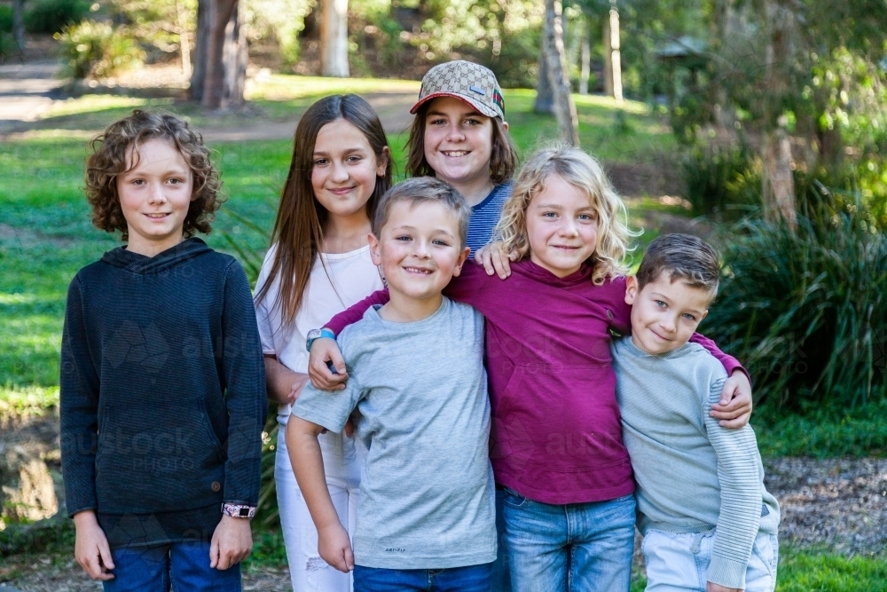 Happy group of children together at a park - Australian Stock Image