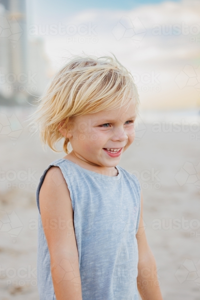 Happy little boy standing on the beach at the Gold Coast - Australian Stock Image