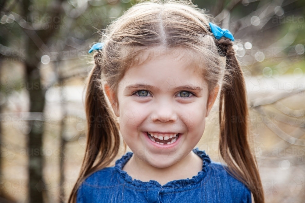 Happy little girl with gap in teeth from first lost tooth - Australian Stock Image