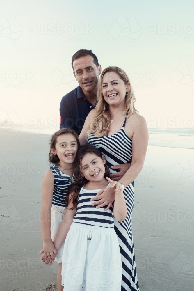 Happy multicultural family on the beach - Australian Stock Image