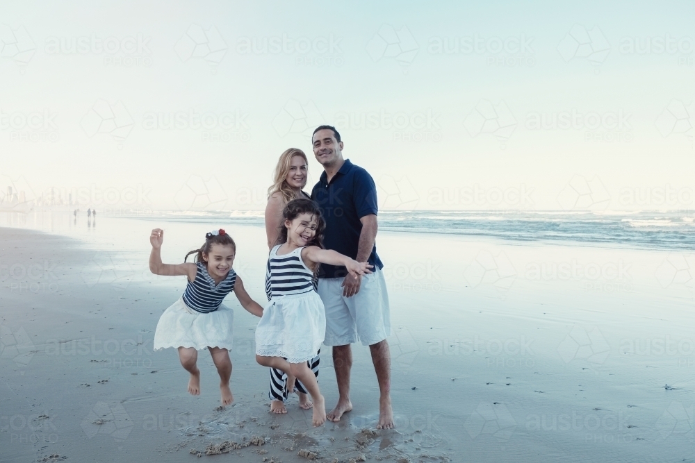 Happy multicultural family on the beach - Australian Stock Image