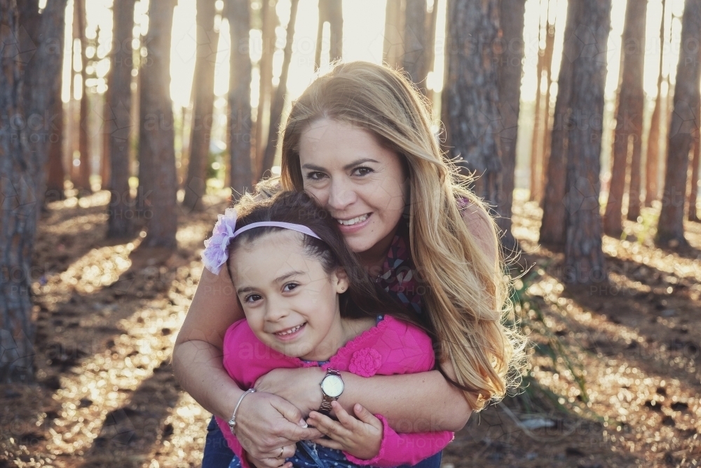 Happy multicultural mother and daughter in the park - Australian Stock Image