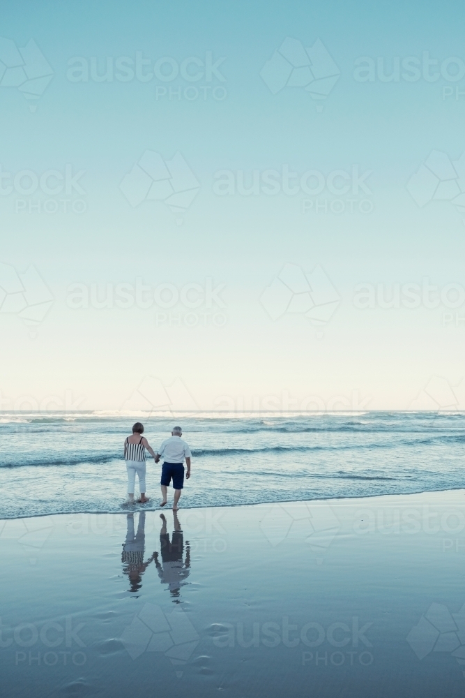 Happy multicultural senior couple on the beach - Australian Stock Image