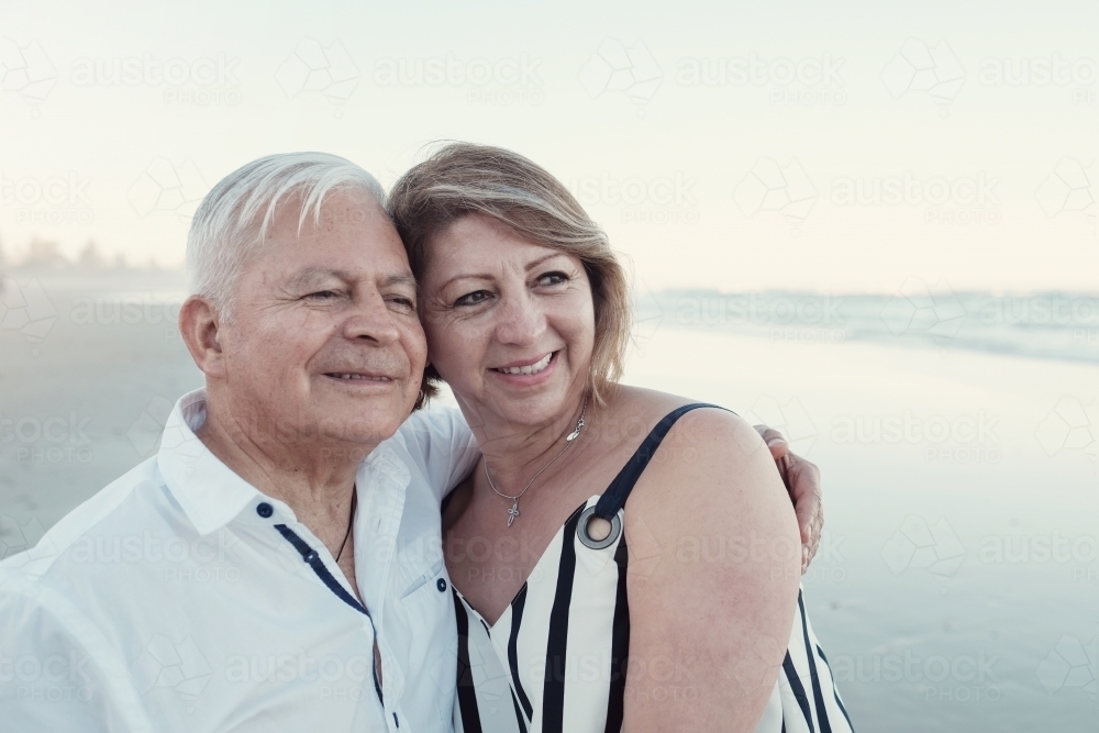 Happy multicultural senior couple on the beach - Australian Stock Image