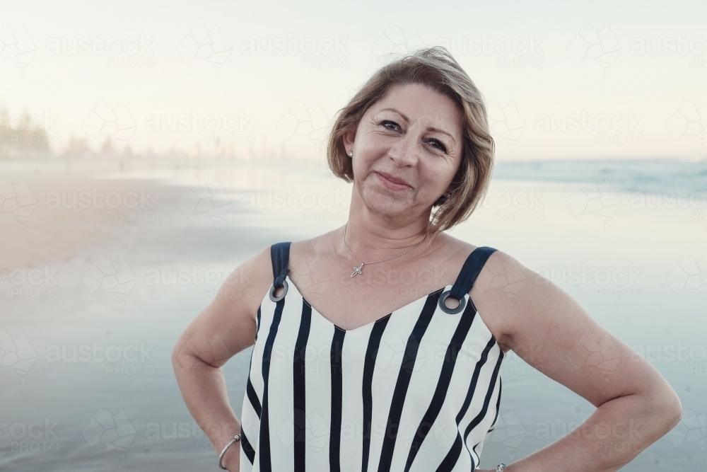 Happy multicultural senior woman on the beach - Australian Stock Image