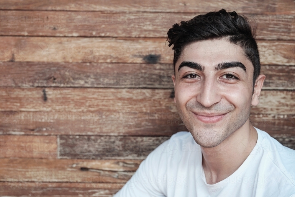 Happy multicultural young adult man, university student - Australian Stock Image