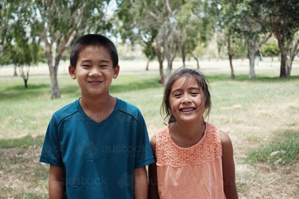 Happy multicultural young children at park - Australian Stock Image