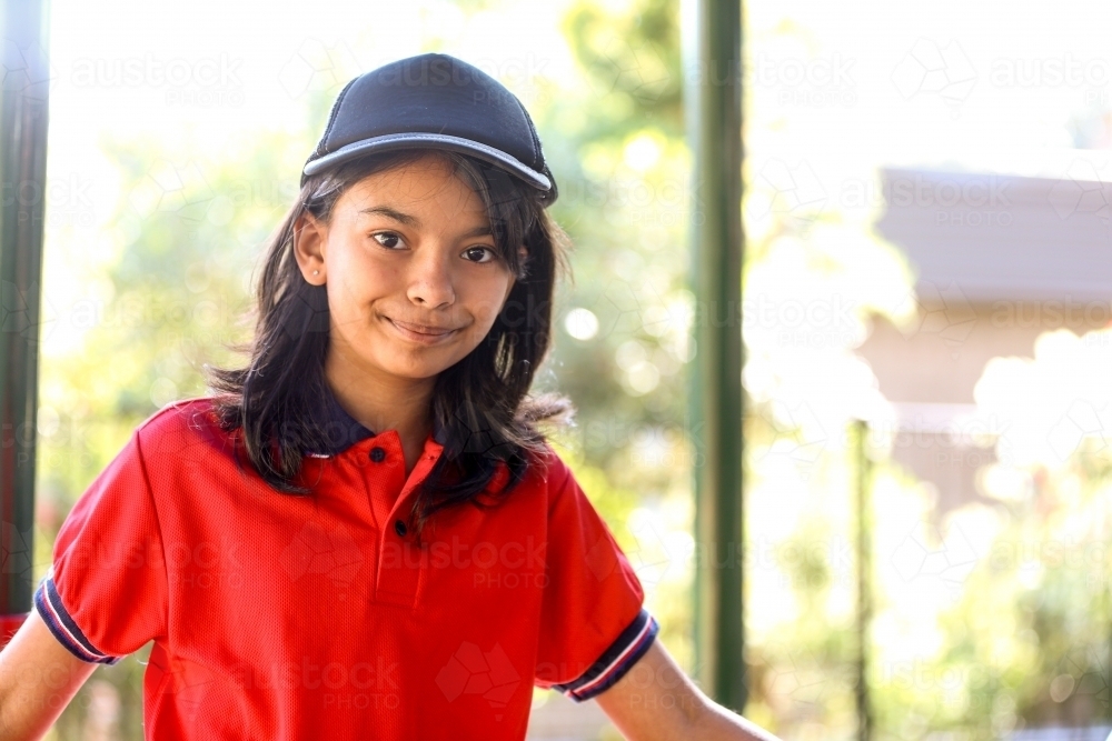 Happy primary school student wearing a cap - Australian Stock Image